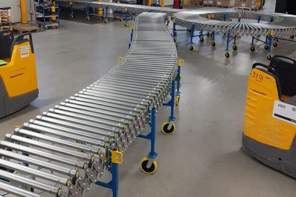Powered harmonica roller conveyor in logistics.